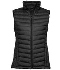 Tee Jays Ladies Zepelin padded bodywarmer shaped gilet with showerproof outer full-length zip chin guard and zipped front pockets